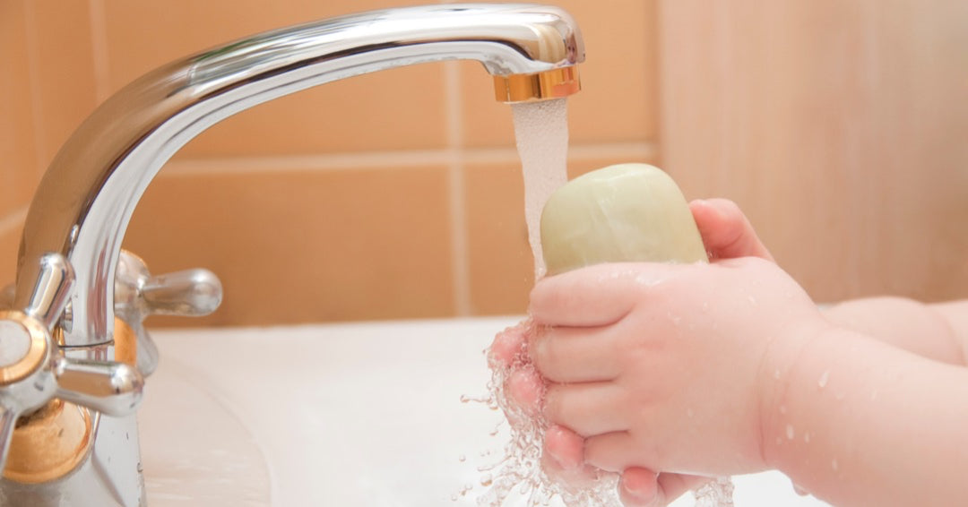 Childs washing hands with Sulphur Soap.